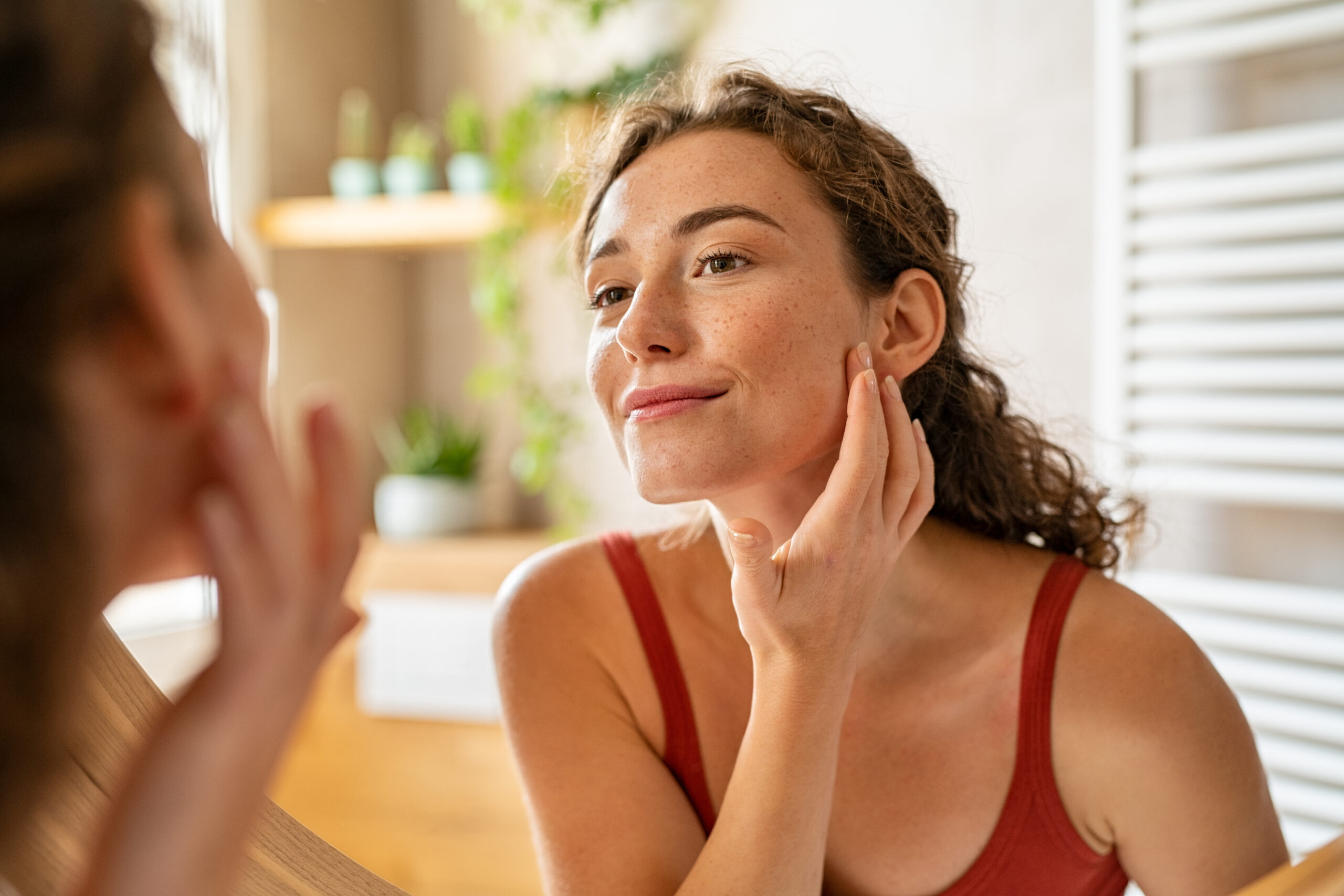 Female model examining her face in the mirror