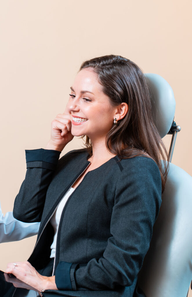 Patient smiling in chair at dermatology associates of the bay area