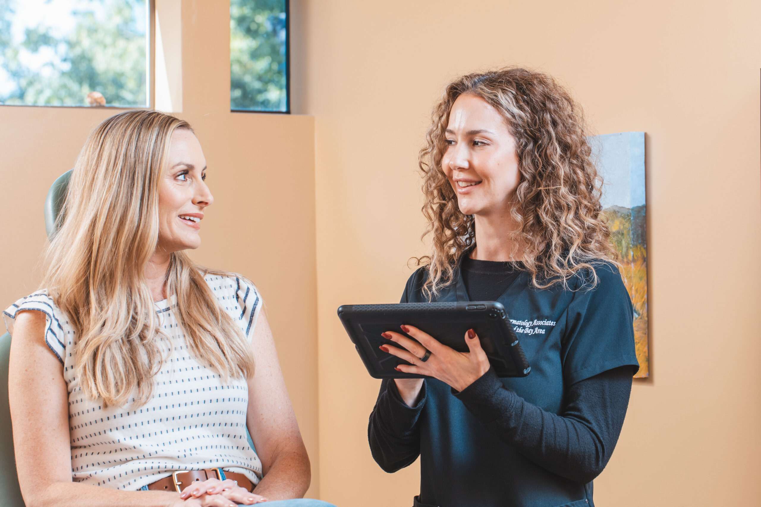 Provider consulting with patient - dermatology office