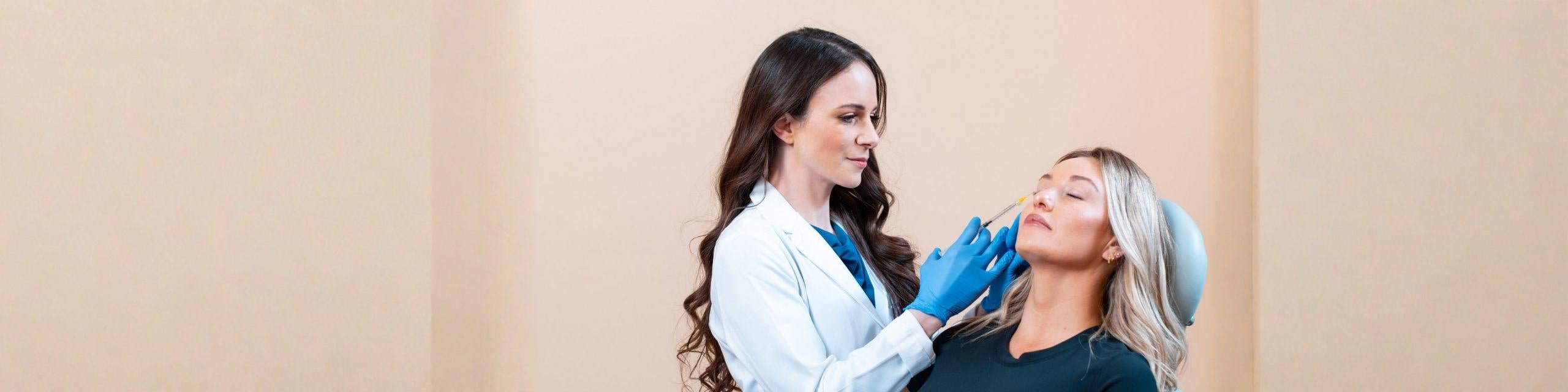 Dr. Fisk injecting happy patient with a neuromodulator