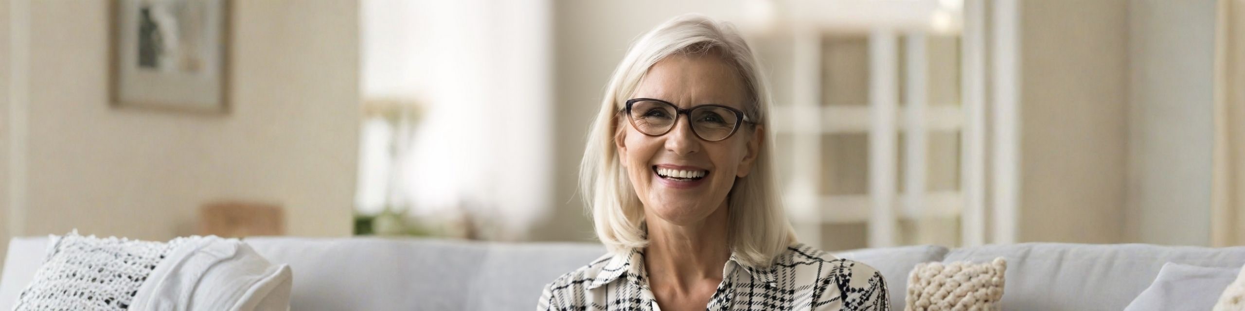 happy woman smiling at camera with glasses on