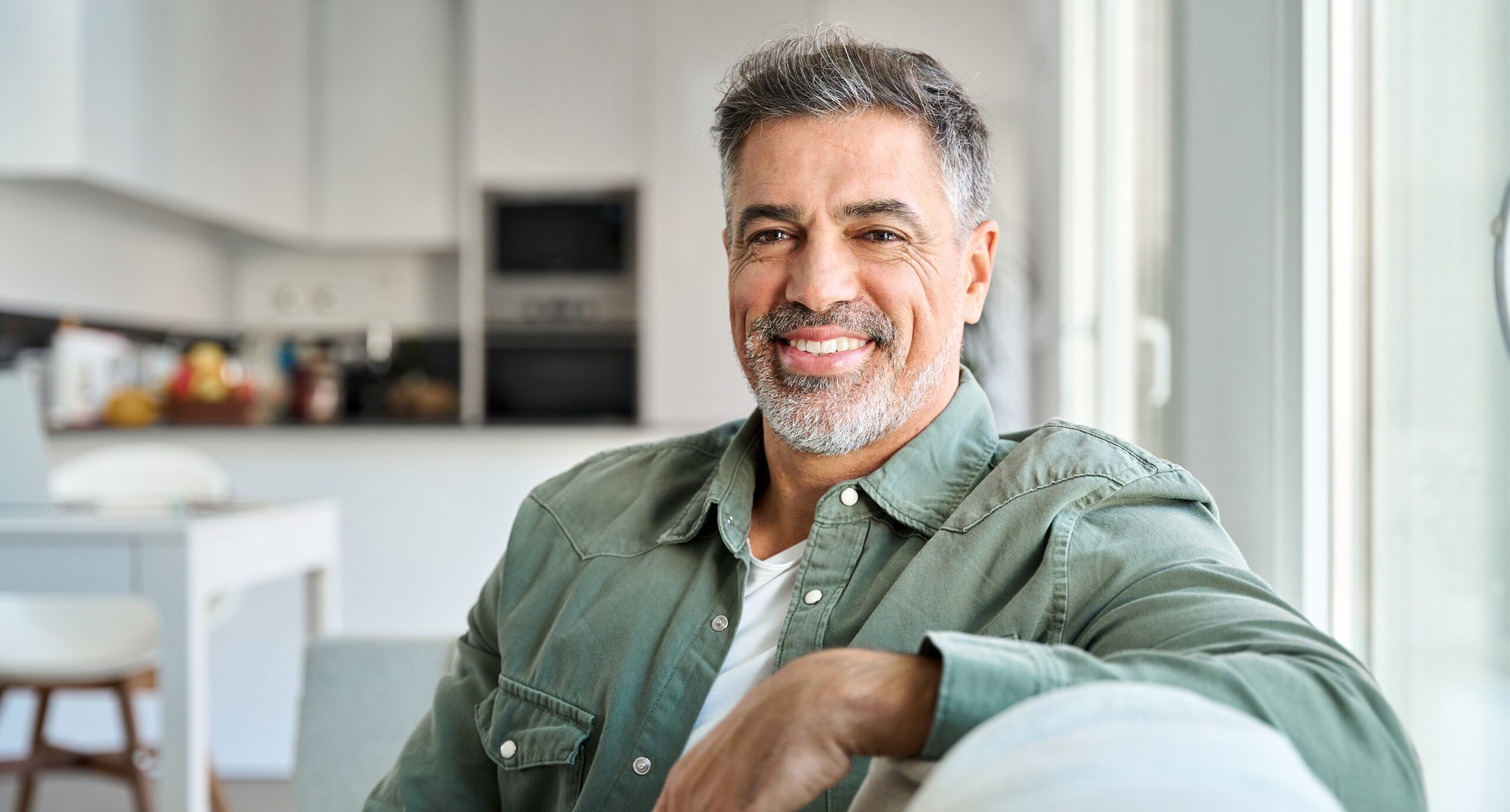 man sitting on couch smiling