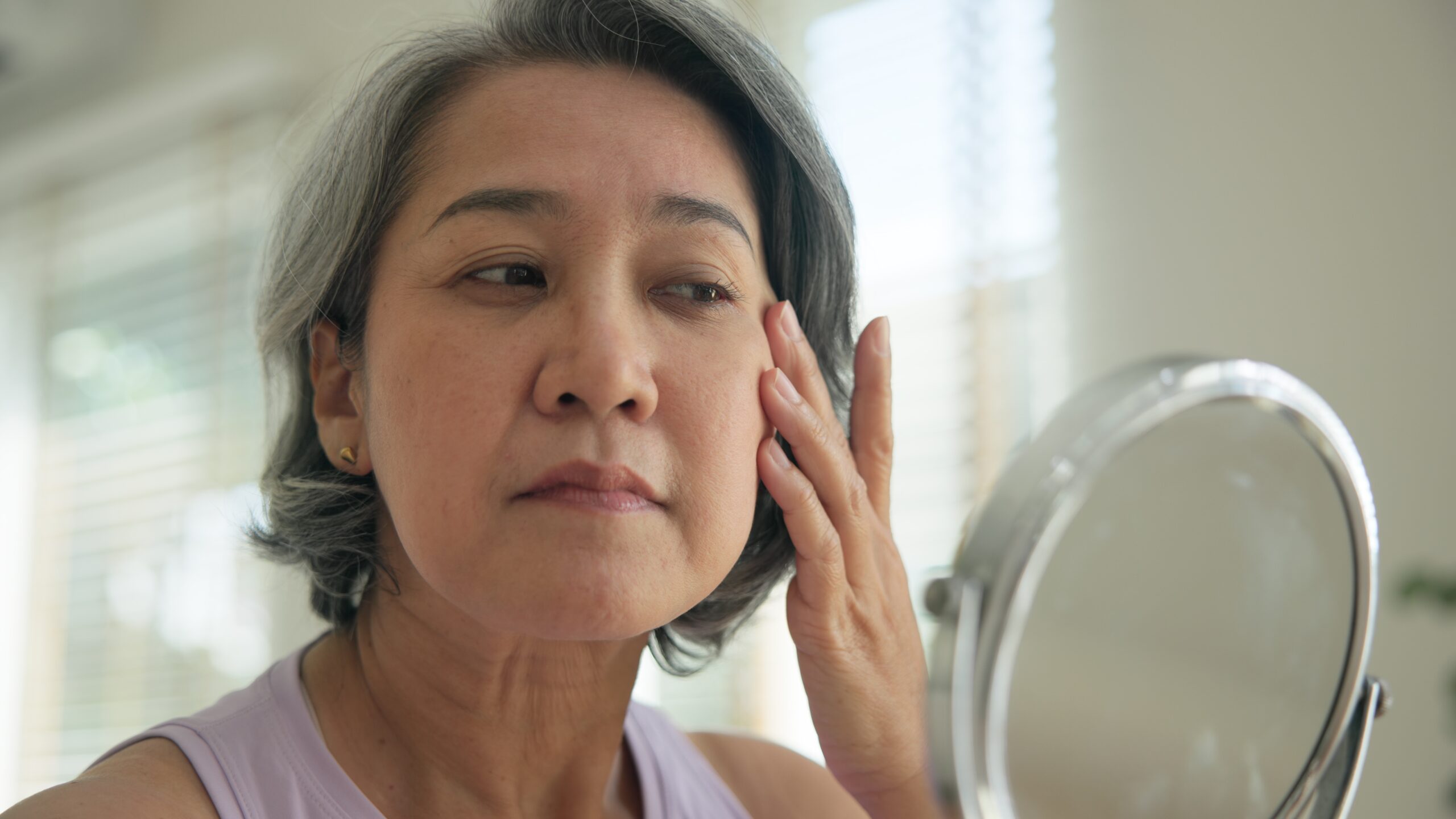 woman looking at skin